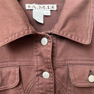 Brown jean jacket with diamond detailed buttons.